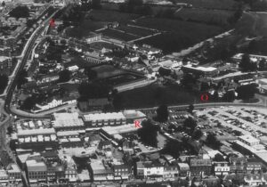 This fascinating aerial view, showing north of Newmarket High Street in the mid to late 1970s, captures several interesting features from a Newmarket medical history point of view: 'E' marks Exning Road Surgery, whist it was a surgery; 'O' marks the future site of Orchard House Surgery, where the former was to move, showing a small cluster of trees that likely represents the orchard after which it was named; 'R' marks The Rookery Medical Centre when newly built, the surgery and the shopping centre both covering a much smaller area than today (see below or click image for source and acknowledgements etc., ref. Image 1).
